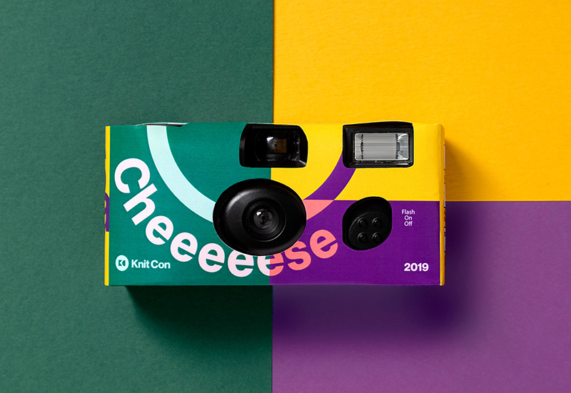 A disposable camera that is wrapped in custom branding that says "CHEEEEESE"